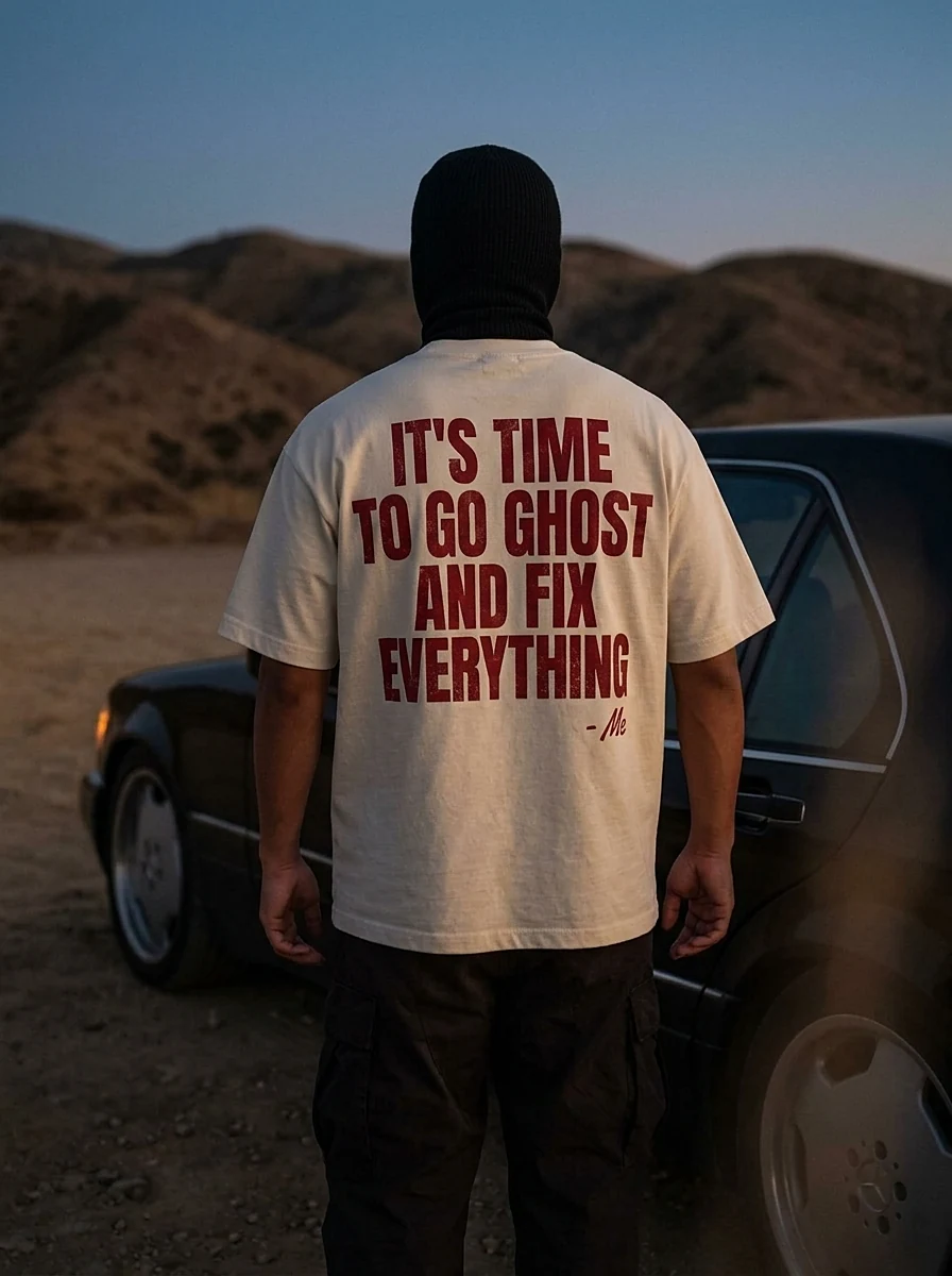 Hooded figure in a cream t-shirt in the desert at dusk