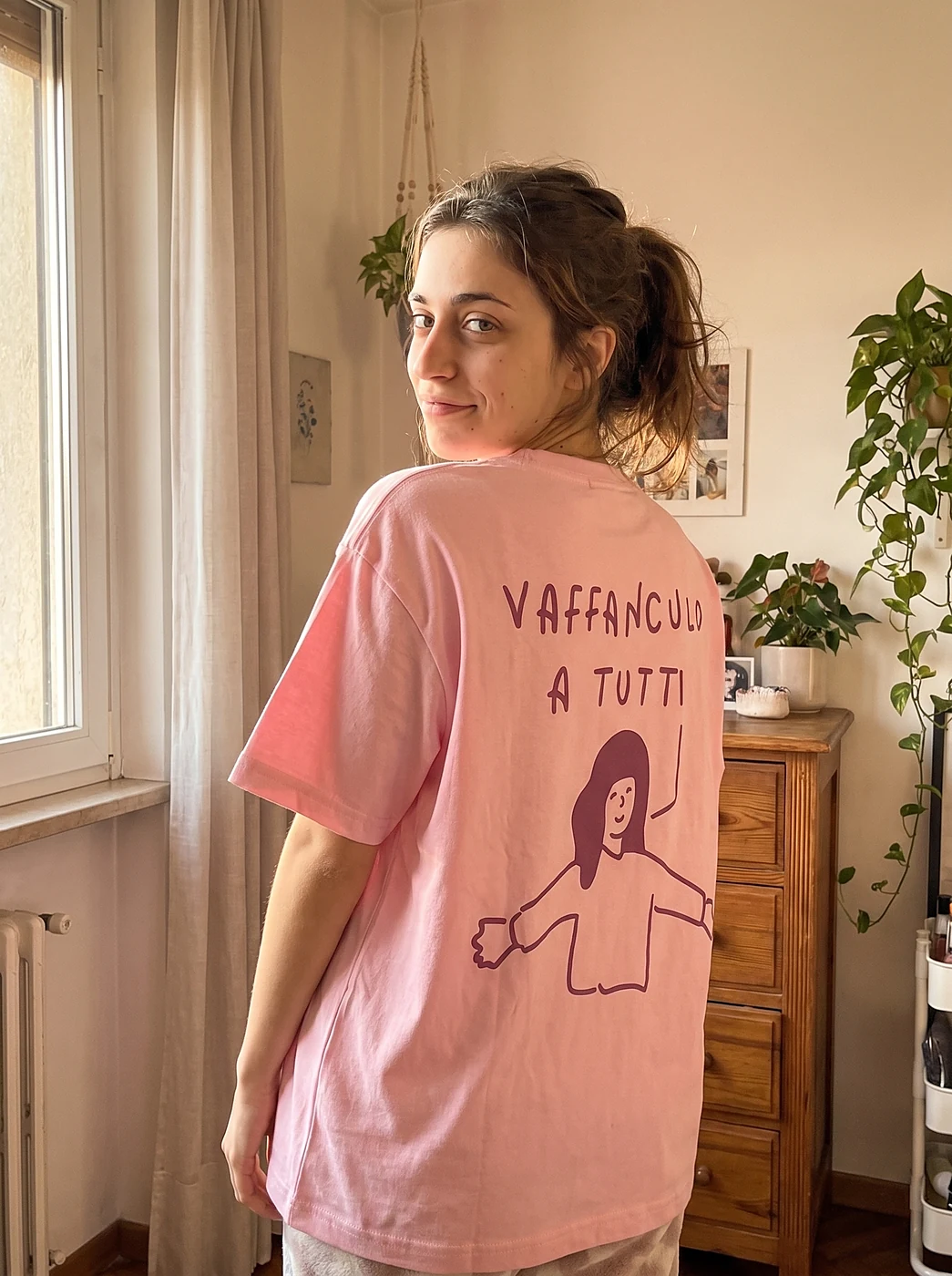 Woman in the pink oversized t-shirt with a plum doodle print